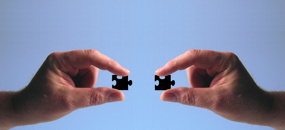 Hands Holding Jigsaw Puzzles